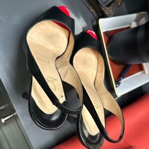 Well kept classic black strappy Louboutins